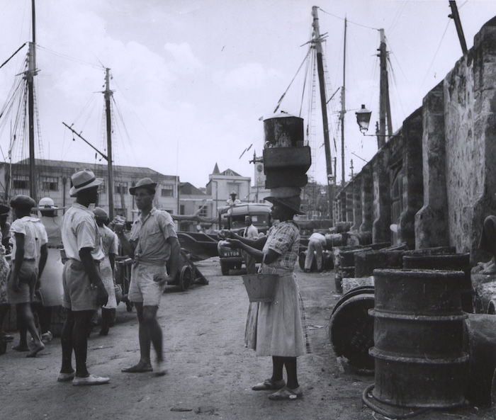 Habour workers in Bridgetown, Barbados take a break, 1950. National Archives. Public Domain.