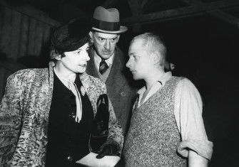 Mavis Tate and Edward Wickham talk with a young Czech survivor in the prisoners’ barracks at Buchenwald, April 1945. Associated Press/Alamy Stock Photo.