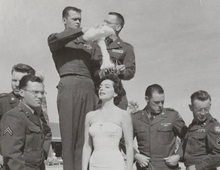 Servicemen crown a Copa Room showgirl ‘Mis-Cue’ to mark the misfiring of the Operation Cue Bomb at Sands Hotel and Casino, Las Vegas, 1955. UNLV University Libraries Special Collections and Archives.