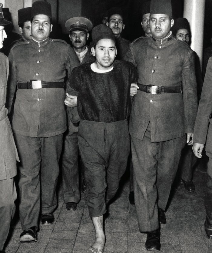 Ibrahim al-Tayyib, one of the six Muslim Brothers who had plotted against Nasser, is led to the gallows, Cairo, 1954. Keystone/Getty Images.
