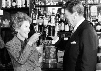 President Ronald Reagan and wife Nancy toast each other at the bar of O'Farrell's Pub in Ballyporeen, while on a four day visit to the Republic of Ireland, 3 June 1984. PA Images/Alamy Stock Photo.