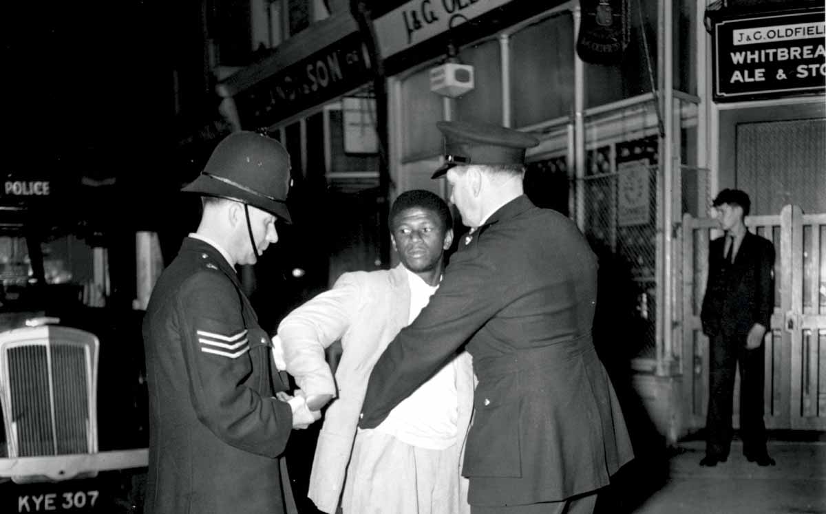 London police search a black youth on Talbot Road, Notting Hill, during the race riots, 3 September 1958 © Getty Images. London police search a black youth on Talbot Road, Notting Hill, during the race riots, 3 September 1958 © Getty Images.